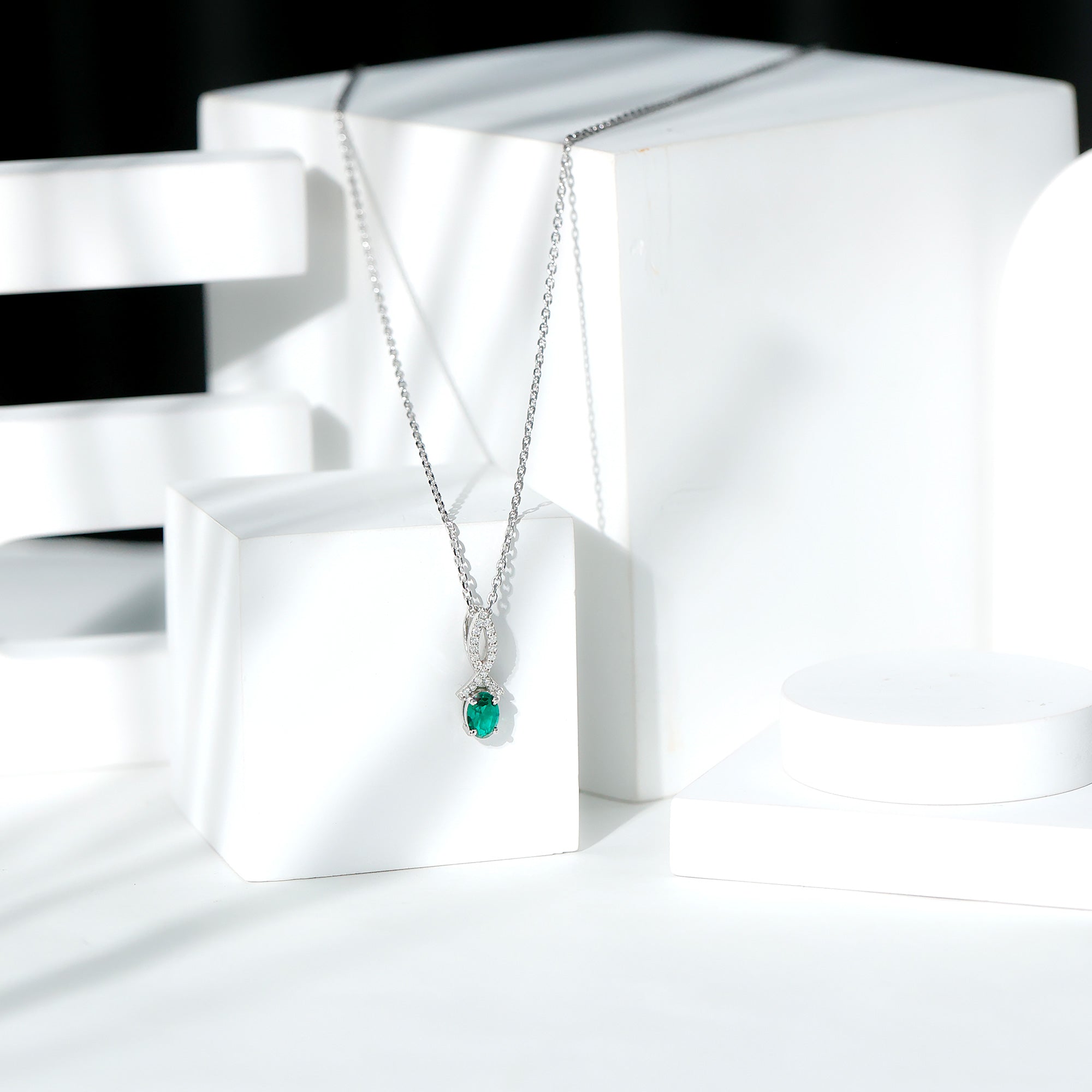 Oval Lab Created Emerald Infinity Pendant with Moissanite in Silver